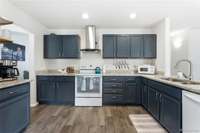 a kitchen with a sink a stove and cabinets