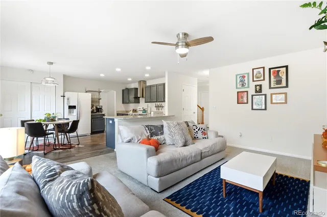 a living room with furniture and kitchen view