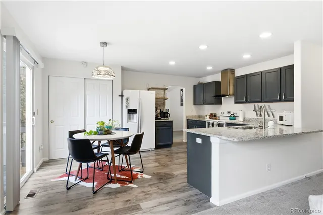a kitchen with stainless steel appliances kitchen island granite countertop a sink and cabinets