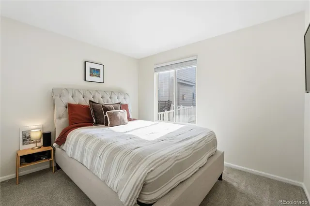 a bed sitting in a bedroom next to a window