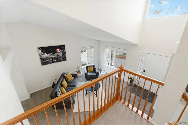 a view of staircase with lots of frames on wall and a window
