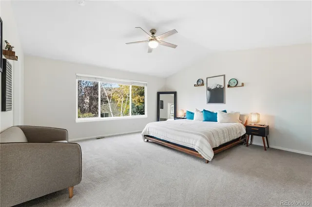 a spacious bedroom with a bed and a couch