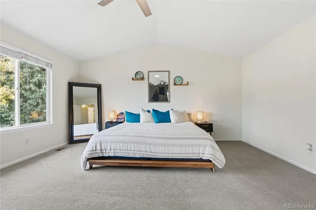 a bedroom with a bed lamp and window