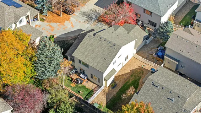 an aerial view of a house with a yard