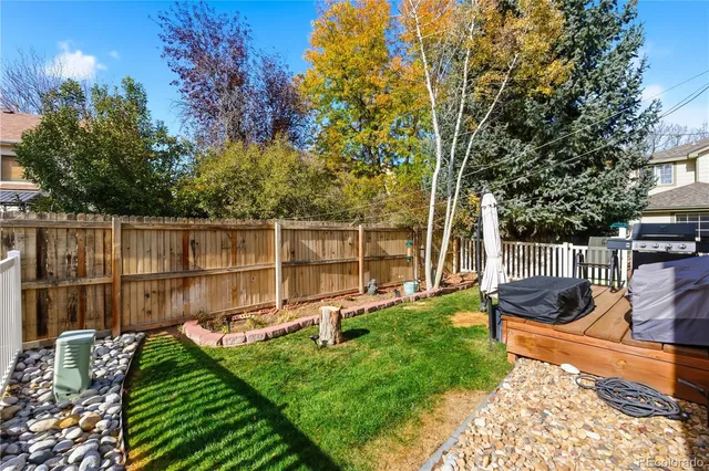 a view of a backyard with wooden fence