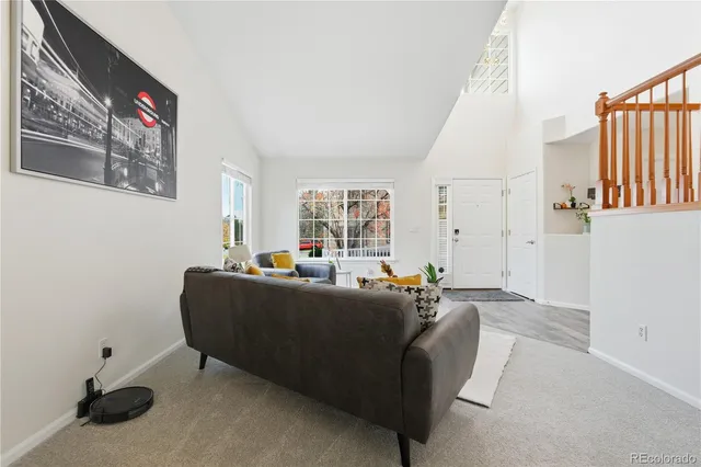 a living room with furniture window and a wooden floor