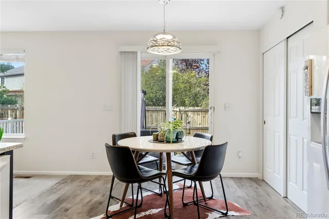 a dining room with furniture a chandelier and wooden floor