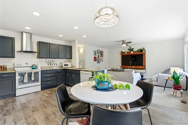 a kitchen with a dining table cabinets and stainless steel appliances