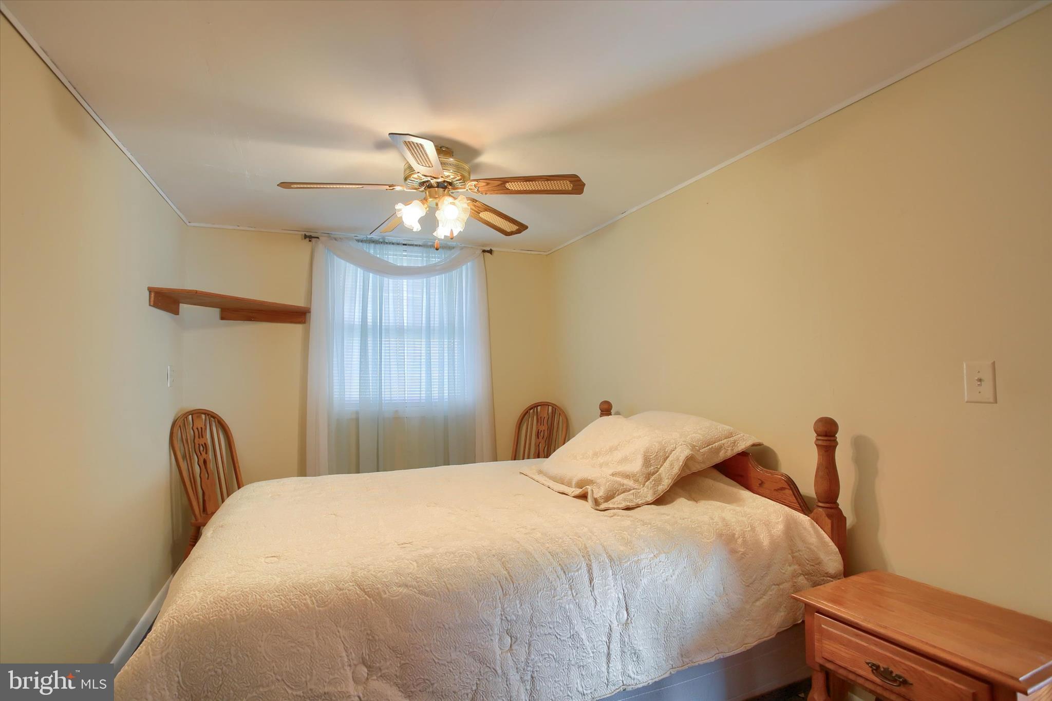 859 Pinetown Road Lewisberry, PA 17339 - Photo 25 of 51 a bedroom with a bed and a chandelier