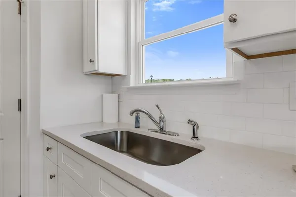a stove top oven sitting inside of a kitchen