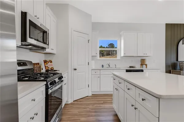 a living room with furniture a flat screen tv and a large window