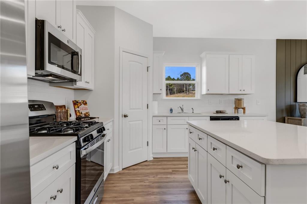 163 Sweet Water Lane Rome, GA 30161 - Photo 16 of 28 a kitchen with stainless steel appliances a sink stove top oven and cabinets