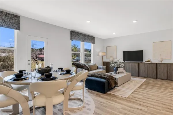 a dining room with furniture and wooden floor