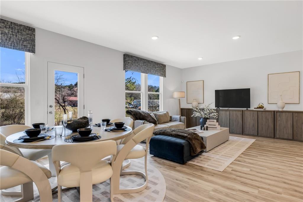 163 Sweet Water Lane Rome, GA 30161 - Photo 17 of 28 a living room with furniture a flat screen tv and a large window