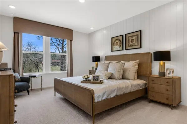 a bedroom with a bed and large windows