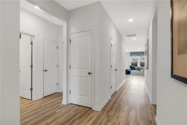 a view of a hallway with wooden floor