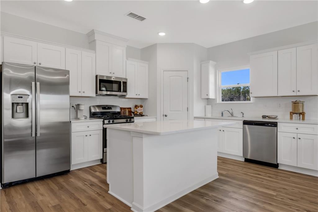 163 Sweet Water Lane Rome, GA 30161 - Photo 10 of 28 a kitchen with stainless steel appliances a refrigerator sink and stove