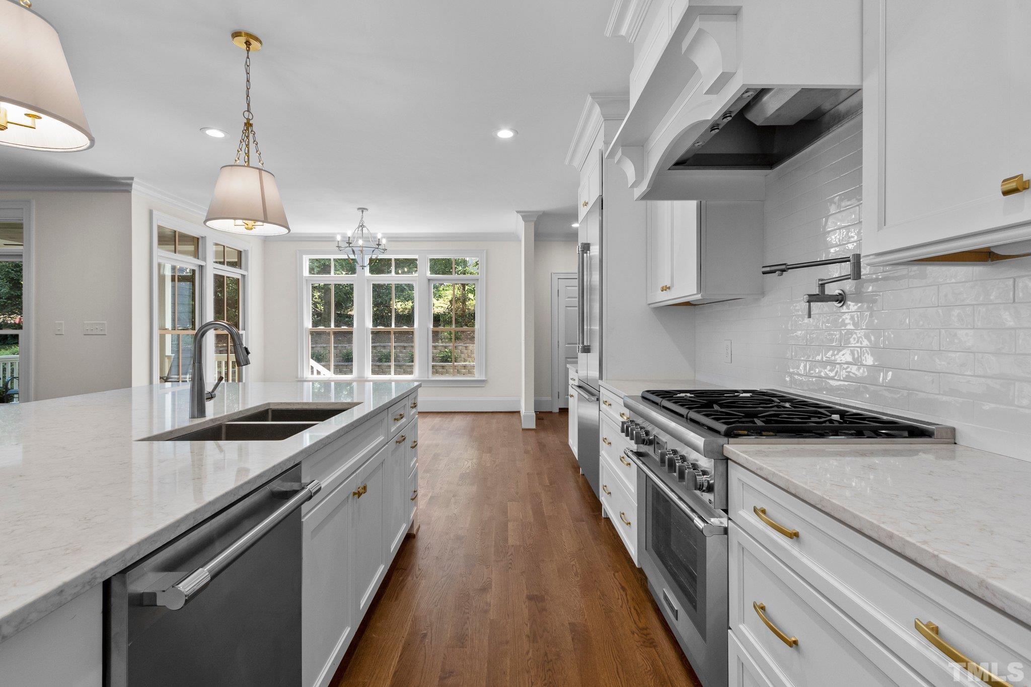 1500 Banbury Road Raleigh, NC 27607 - Photo 11 of 39 a kitchen with stainless steel appliances granite countertop a stove and a sink