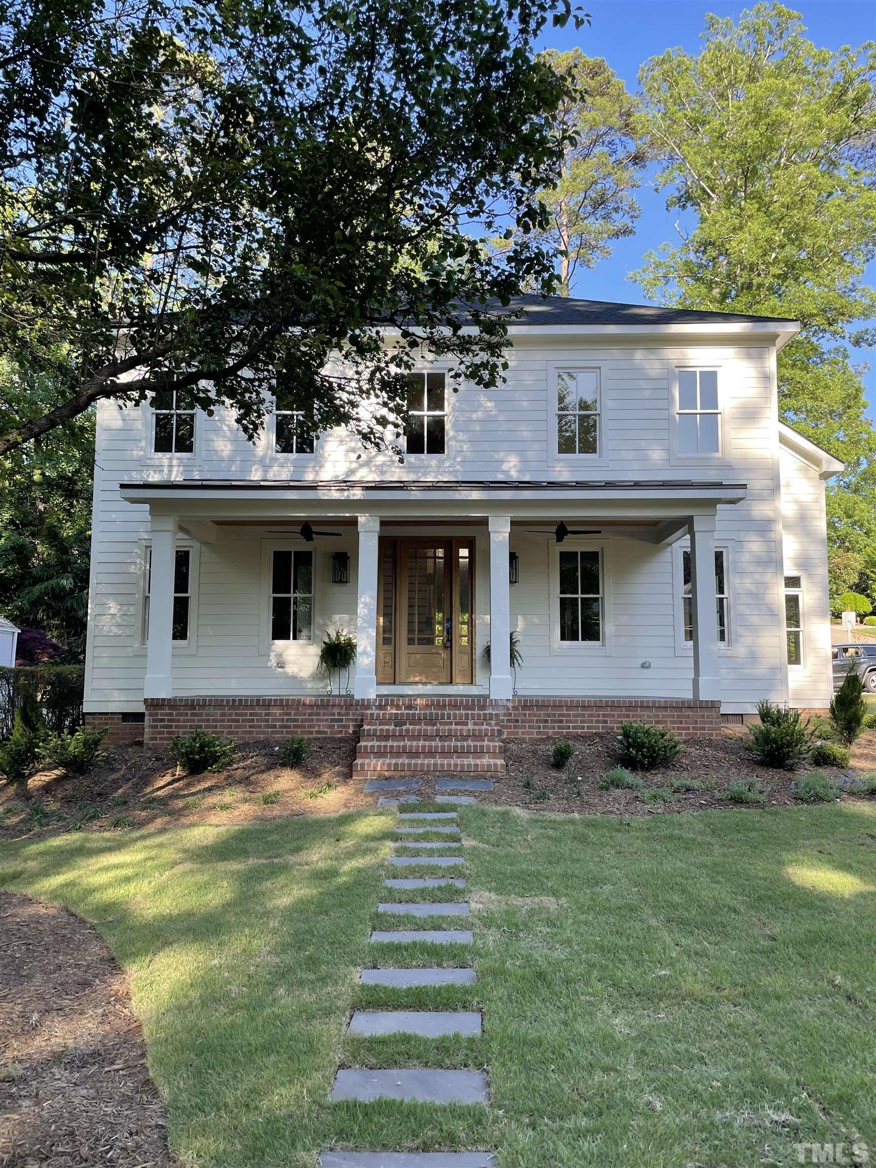 1500 Banbury Road Raleigh, NC 27607 - Photo 2 of 39 a front view of a house with a garden