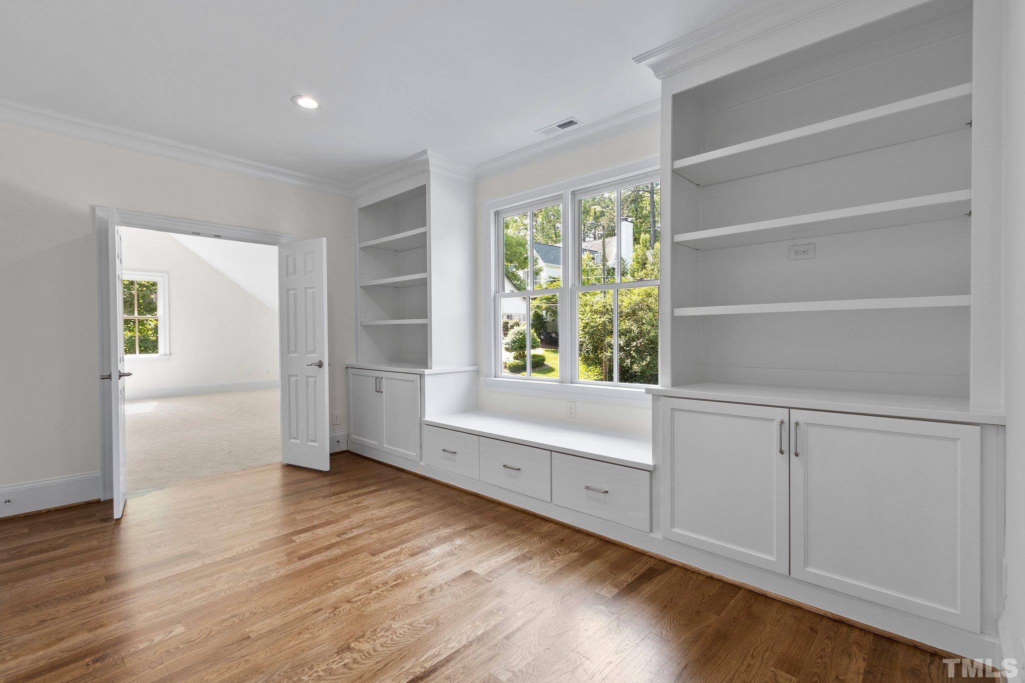 1500 Banbury Road Raleigh, NC 27607 - Photo 24 of 39 a view of an empty room with a window and wooden floor