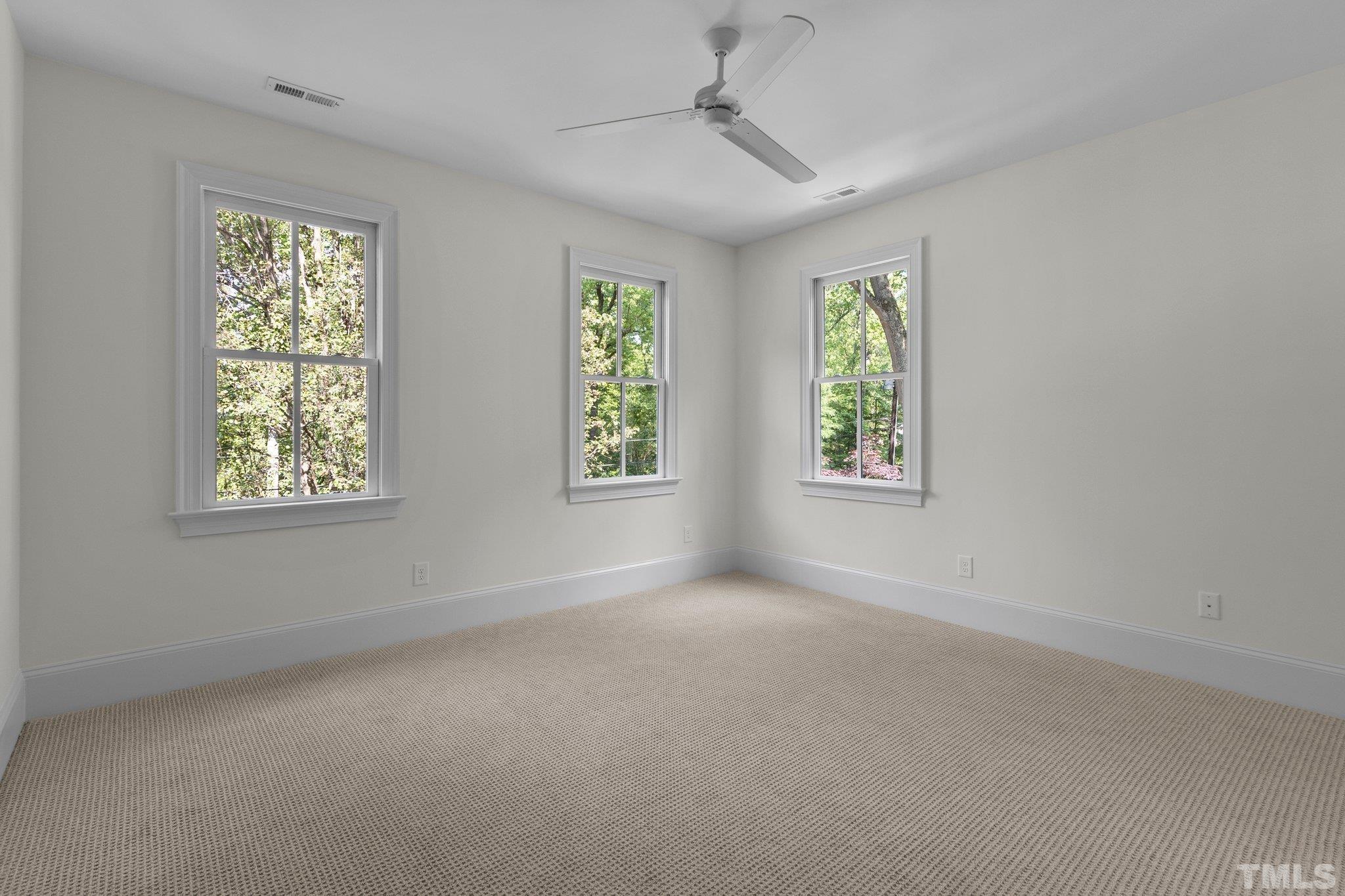 1500 Banbury Road Raleigh, NC 27607 - Photo 27 of 39 en empty room with windows and chandelier fan