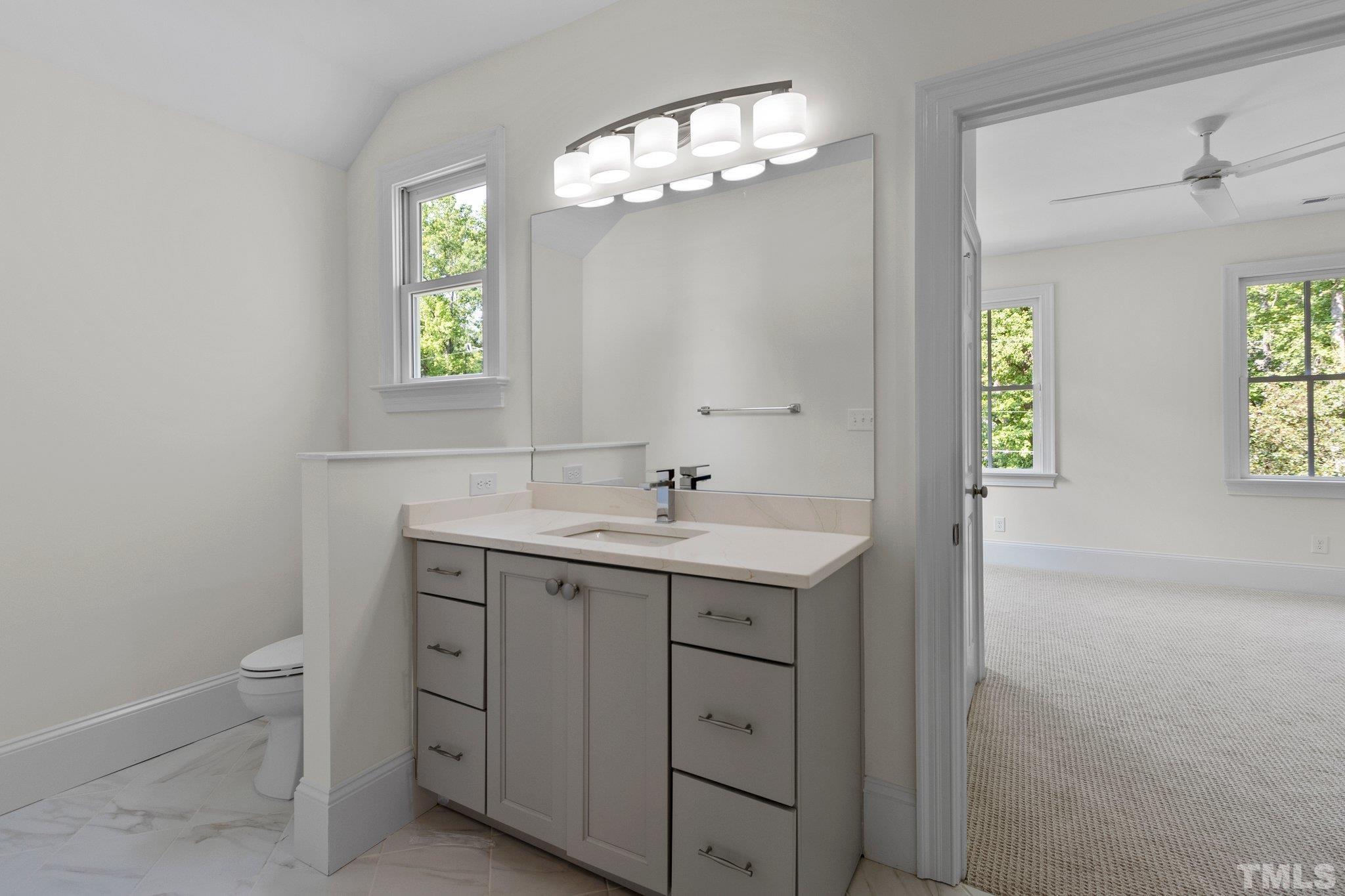 1500 Banbury Road Raleigh, NC 27607 - Photo 30 of 39 a bathroom with a toilet a sink a and a window