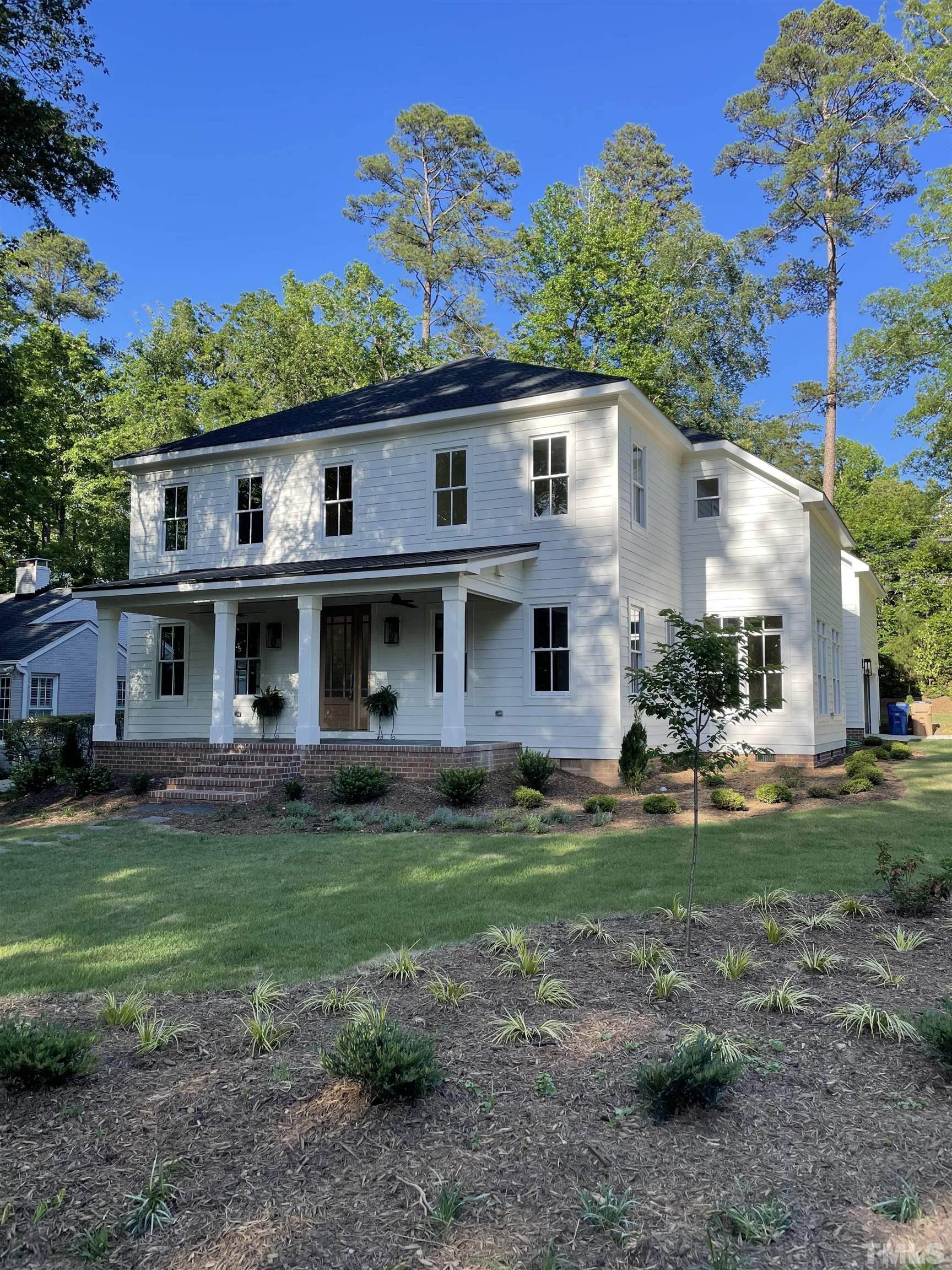 1500 Banbury Road Raleigh, NC 27607 - Photo 3 of 39 a view of a yard in front of a house with plants and large tree