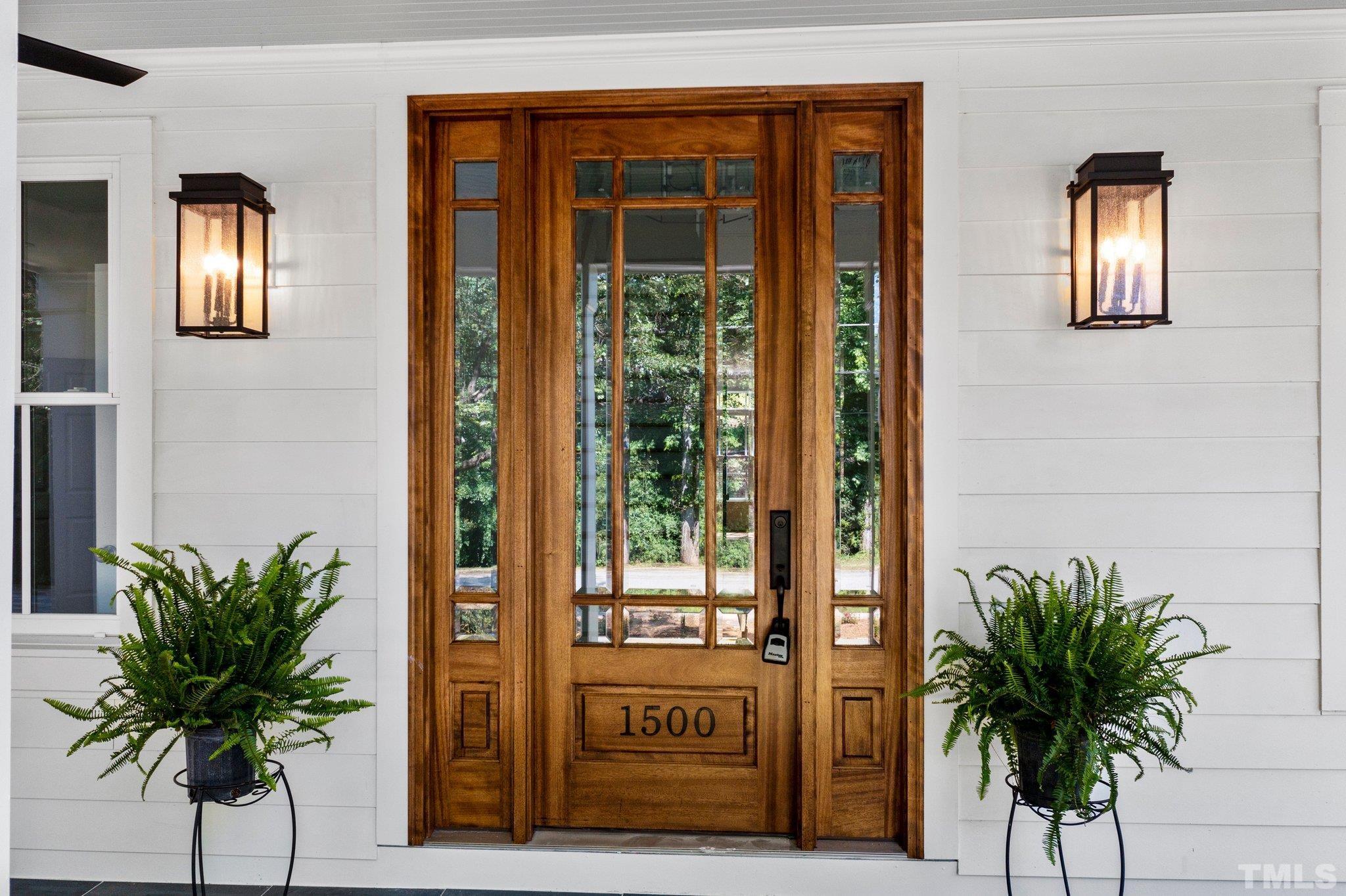 1500 Banbury Road Raleigh, NC 27607 - Photo 5 of 39 a potted plant sitting in front of a door