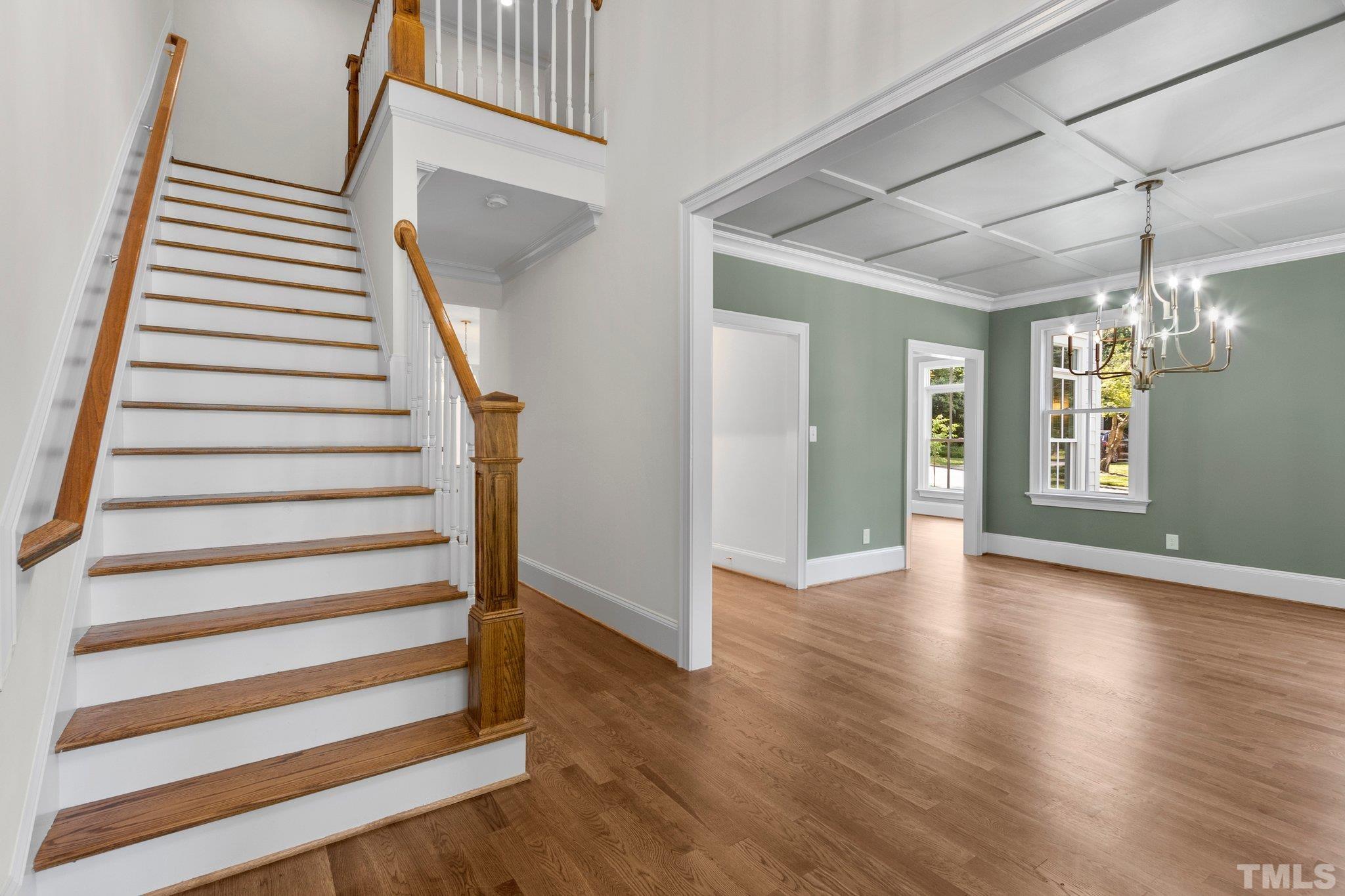 1500 Banbury Road Raleigh, NC 27607 - Photo 6 of 39 a view of a hallway with wooden floor and stairs