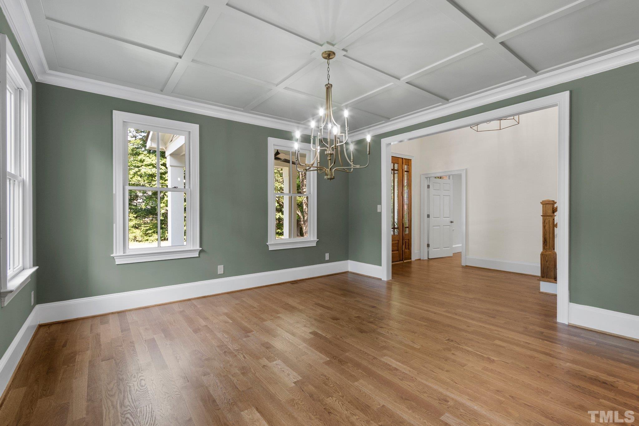 1500 Banbury Road Raleigh, NC 27607 - Photo 7 of 39 a view of an empty room with wooden floor and a window