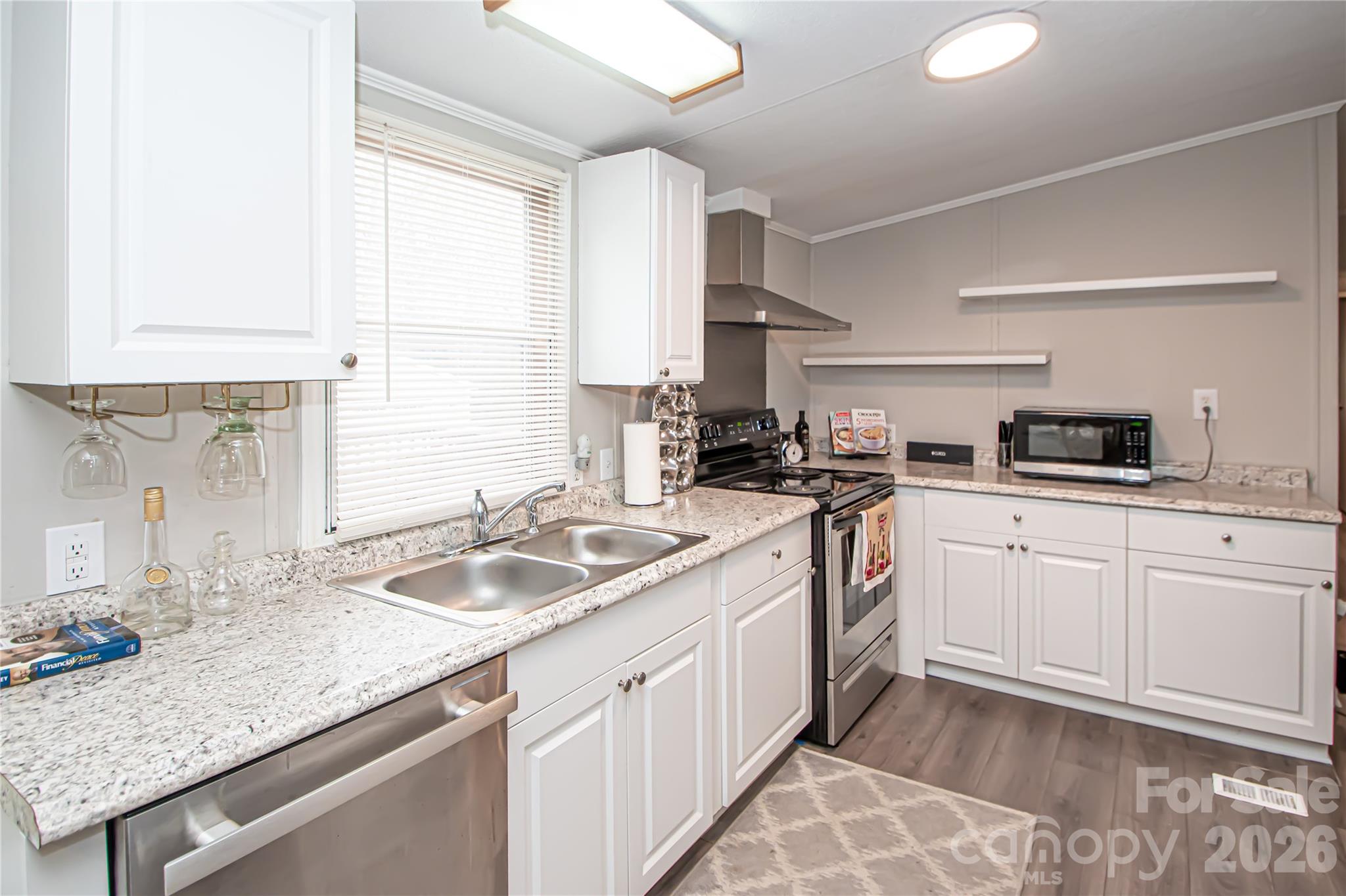 2345 Kingsburry Road York, SC 29745 - Photo 16 of 43 a kitchen with granite countertop kitchen island a sink a counter space and a window