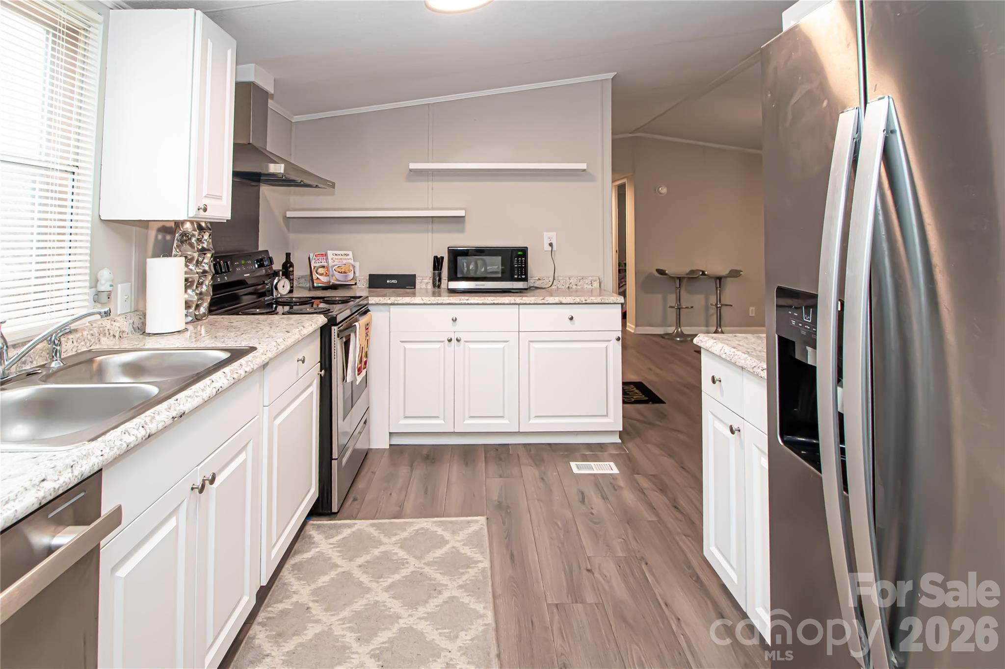 2345 Kingsburry Road York, SC 29745 - Photo 19 of 43 a kitchen with a sink dishwasher a refrigerator and a stove with wooden floor