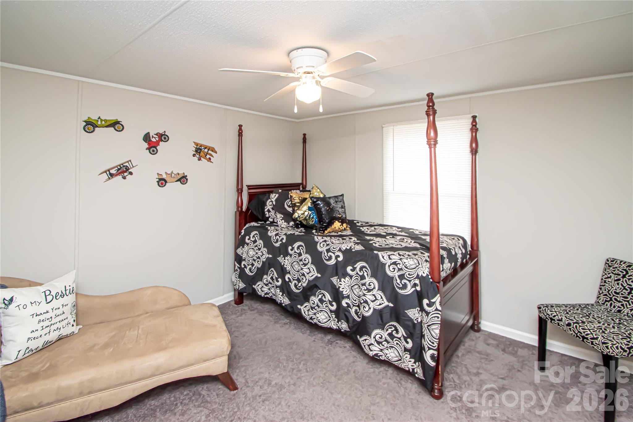 2345 Kingsburry Road York, SC 29745 - Photo 27 of 43 a bed sitting in a bedroom next to a window with a chandelier
