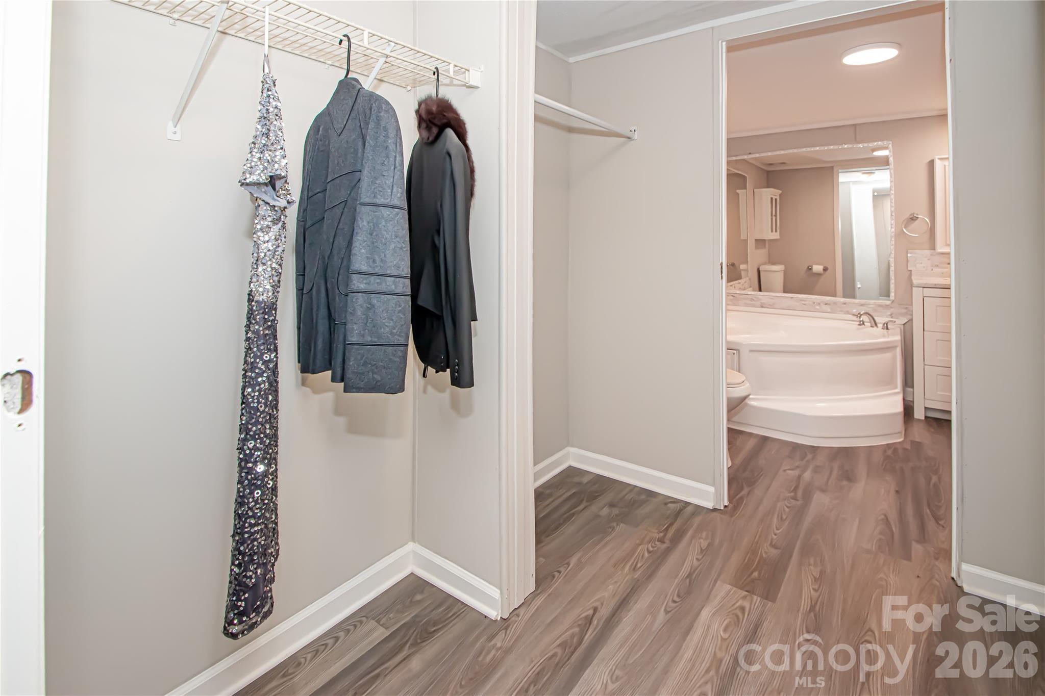 2345 Kingsburry Road York, SC 29745 - Photo 37 of 43 a bathroom with a walk in closet and wooden floor