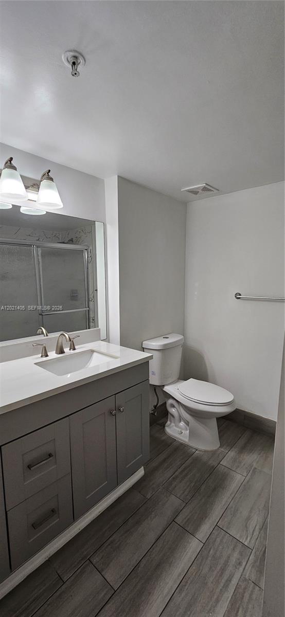 3870 Lyons Road, Unit 2098 Pompano Beach, FL 33073 - Photo 29 of 31 a bathroom with a toilet a sink and mirror