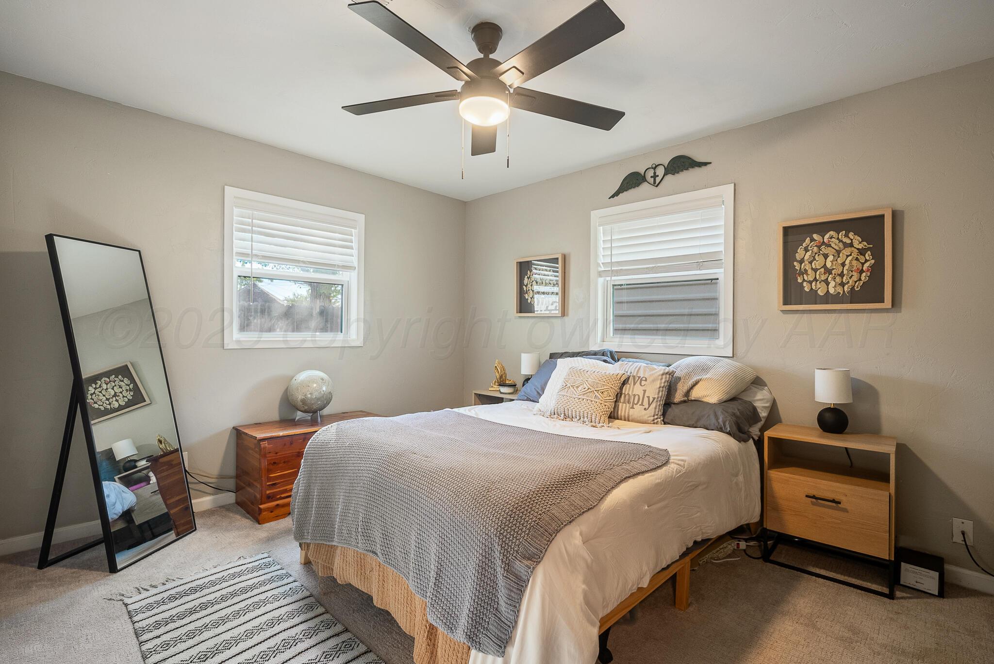 2220 Southeast 19th Avenue Amarillo, TX 79103 - Photo 14 of 25 a bedroom with bed and a chandelier
