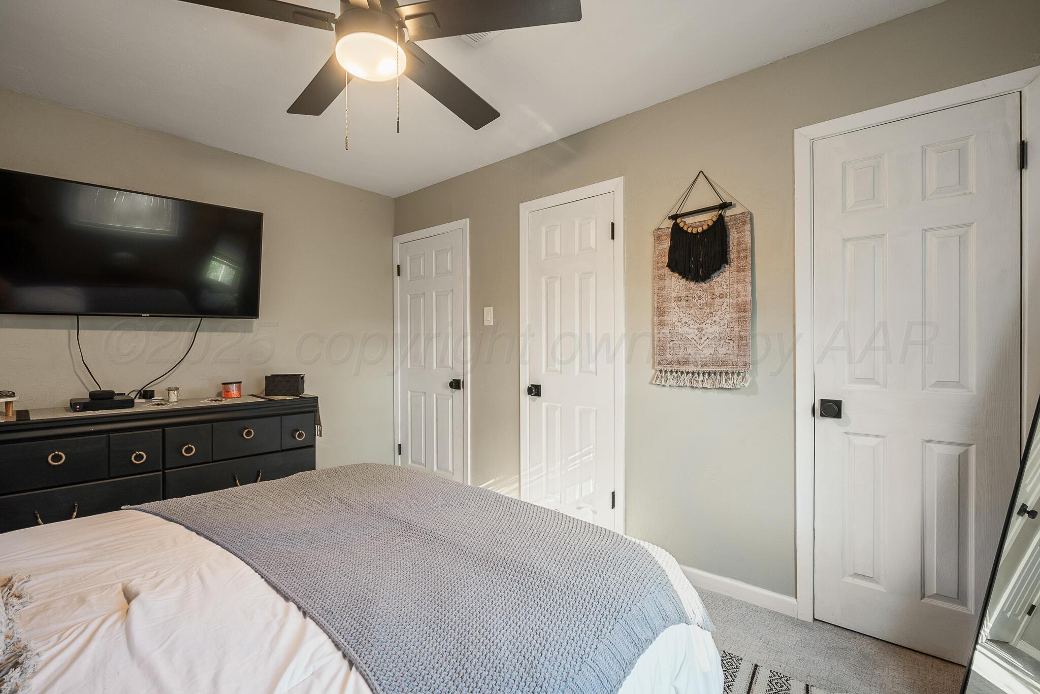 2220 Southeast 19th Avenue Amarillo, TX 79103 - Photo 15 of 25 a bed room with a bed and a flat screen tv