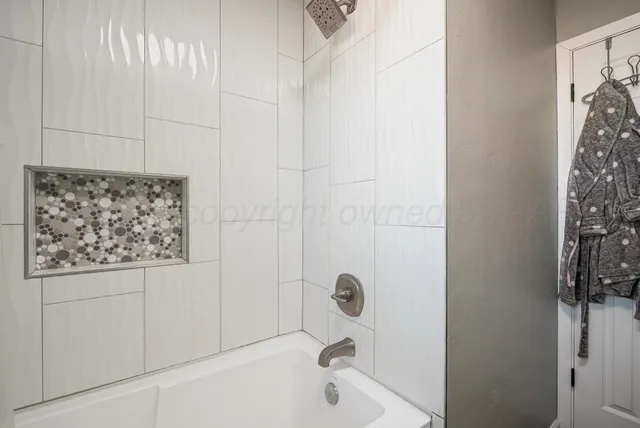 a bathroom with a bathtub and shower