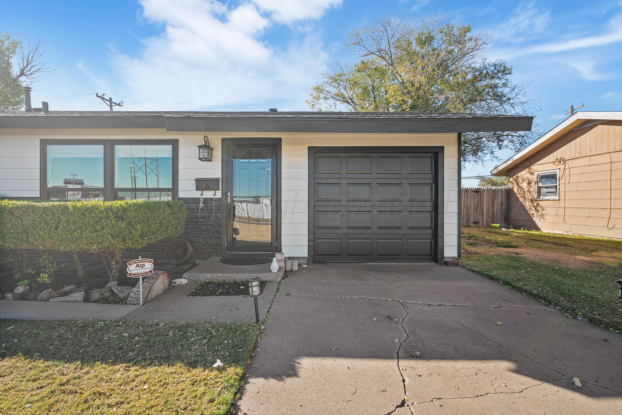 2220 Southeast 19th Avenue Amarillo, TX 79103 - Photo 2 of 25 a front view of a house with a yard