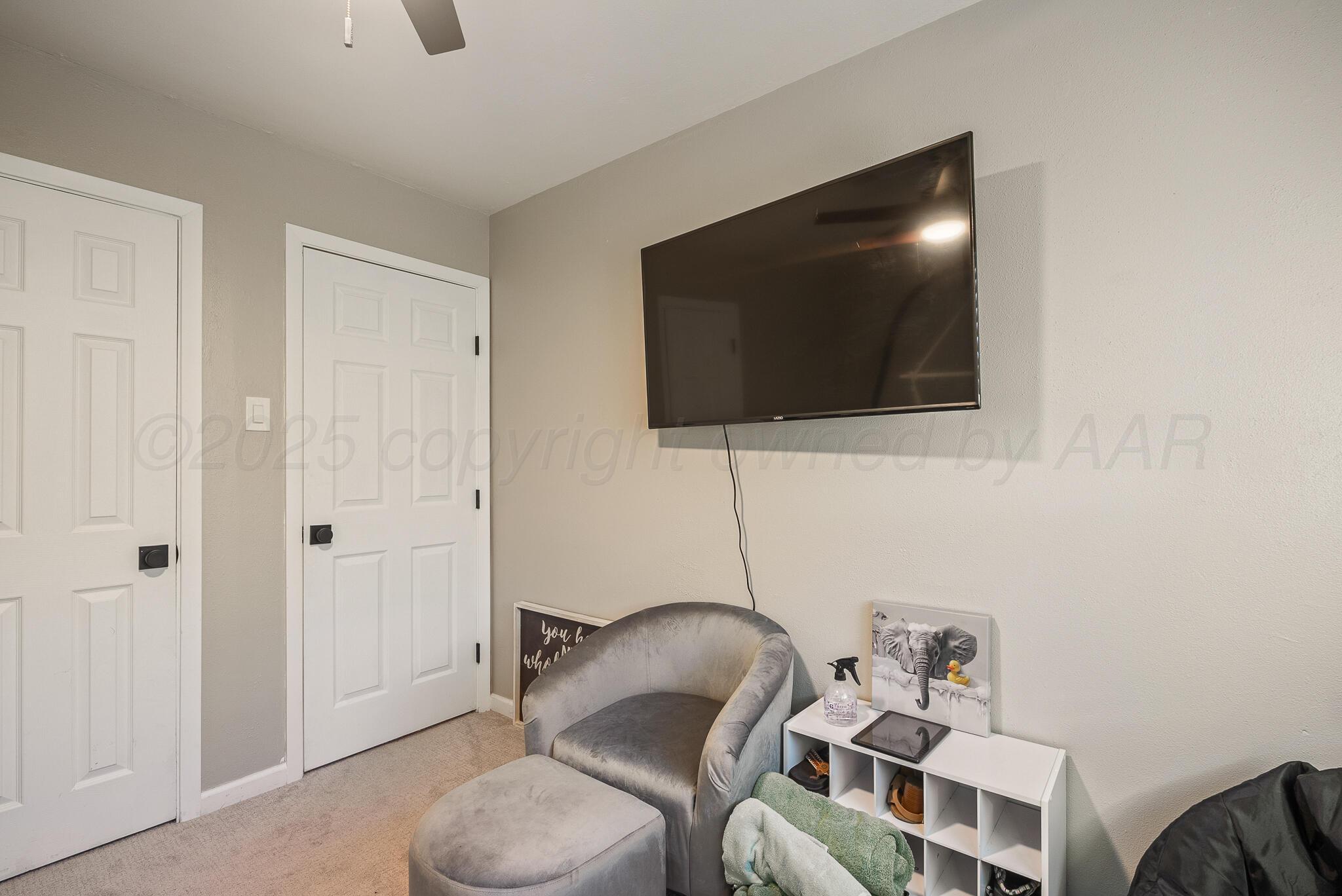 2220 Southeast 19th Avenue Amarillo, TX 79103 - Photo 21 of 25 a living room with furniture and a flat screen tv