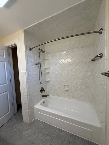 a bathroom with a bathtub and a shower