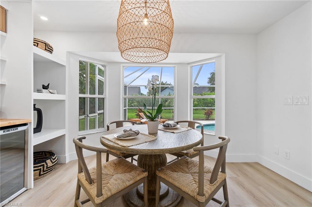 548 Ibis Way Naples, FL 34110 - Photo 16 of 45 a view of a dining room with furniture window and wooden floor