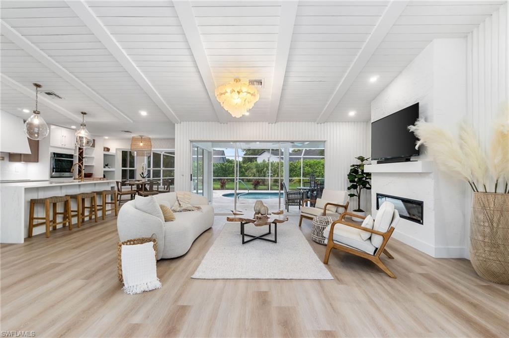 548 Ibis Way Naples, FL 34110 - Photo 2 of 45 a living room with fireplace furniture and a flat screen tv