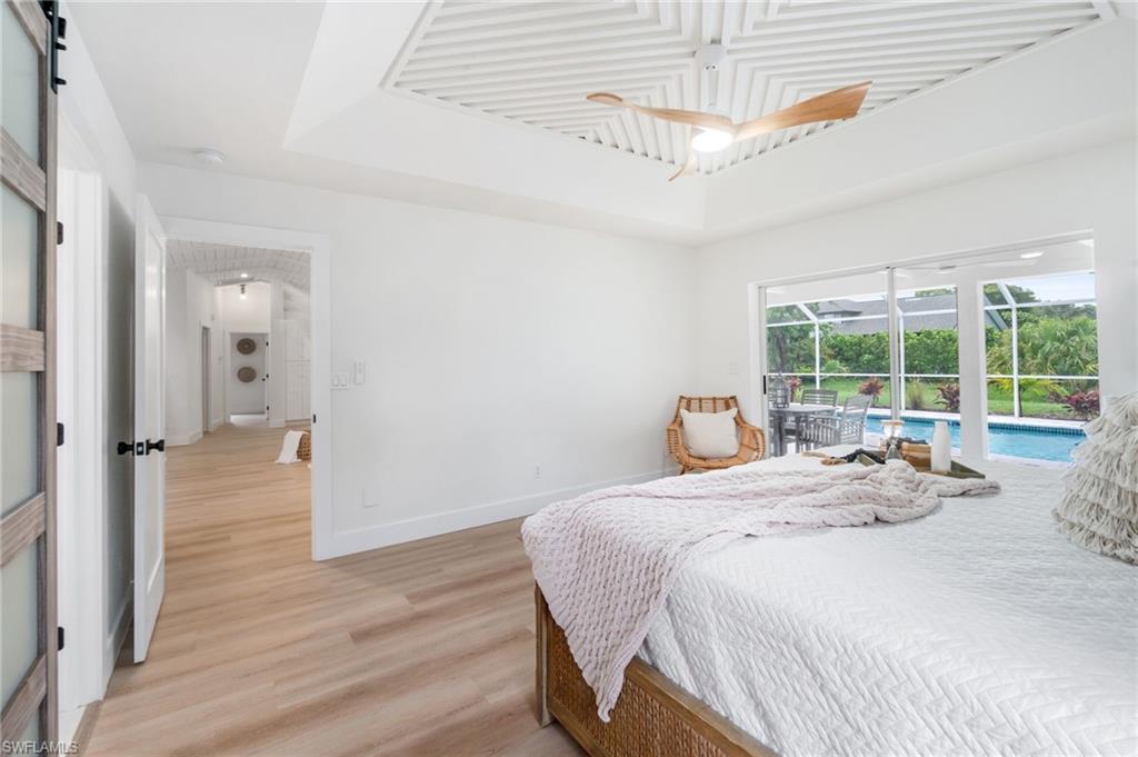 548 Ibis Way Naples, FL 34110 - Photo 21 of 45 a bedroom with a bed and a large window