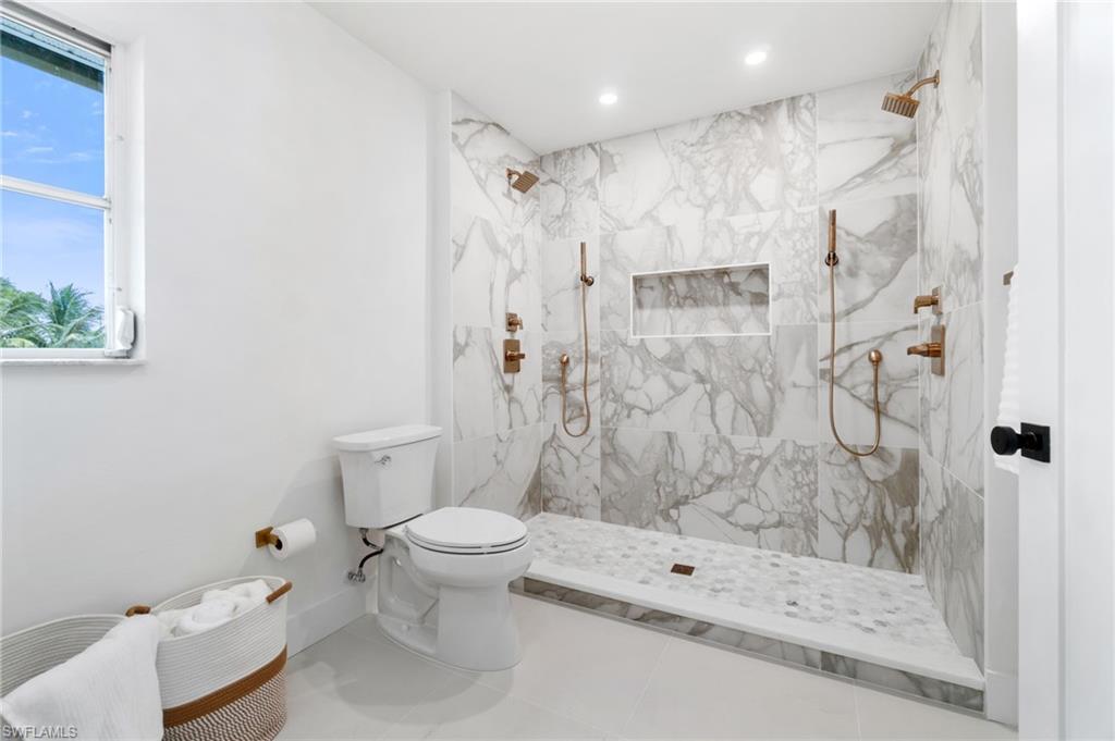 548 Ibis Way Naples, FL 34110 - Photo 22 of 45 a bathroom with a shower toilet and a sink