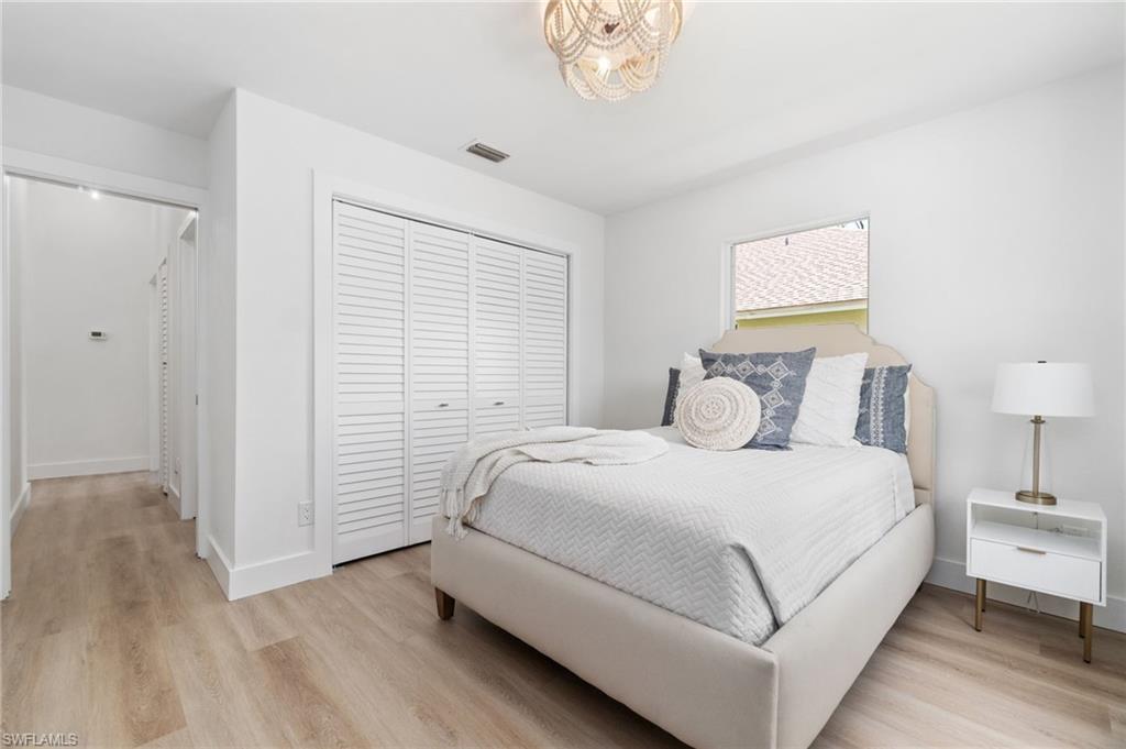 548 Ibis Way Naples, FL 34110 - Photo 25 of 45 a large white bed in a white room