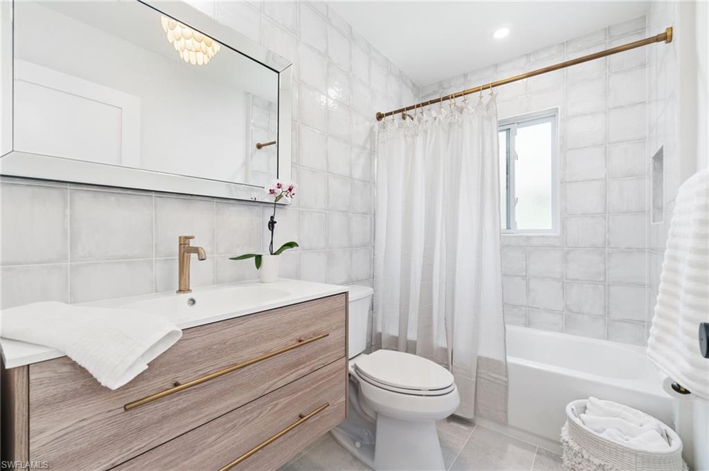 548 Ibis Way Naples, FL 34110 - Photo 26 of 45 a bathroom with a sink a toilet and shower