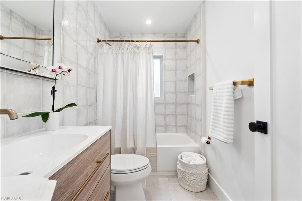 548 Ibis Way Naples, FL 34110 - Photo 27 of 45 a bathroom with a sink toilet and shower