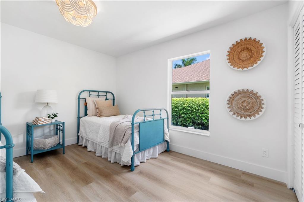 548 Ibis Way Naples, FL 34110 - Photo 29 of 45 a bedroom with a bed and a window