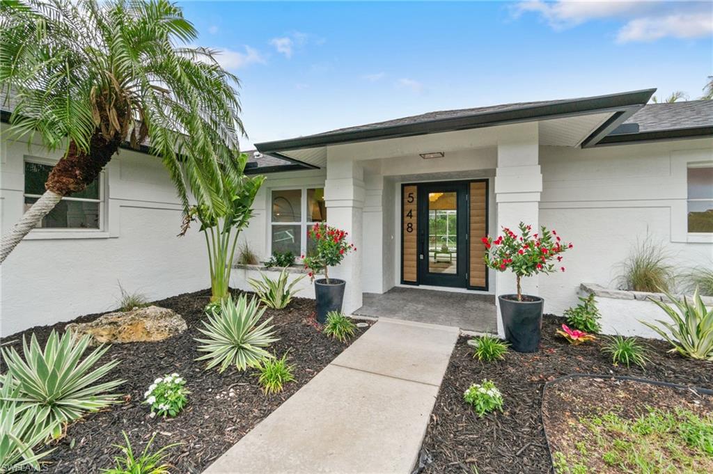 548 Ibis Way Naples, FL 34110 - Photo 33 of 45 a front view of a house with a garden